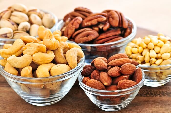 nuts and seeds in bowls on table